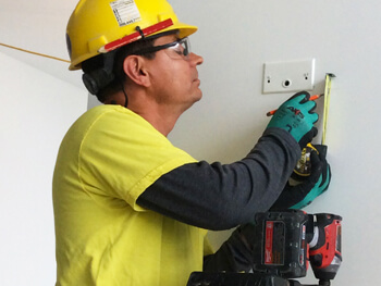 Electrician providing electrical maintenance services.
